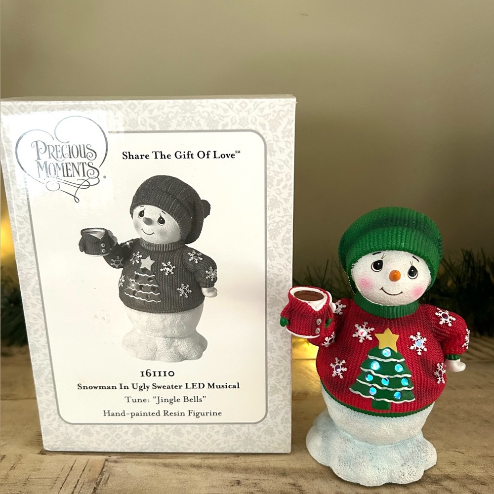Christmas Precious Moments musical snowman figurine wearing an "ugly sweater".